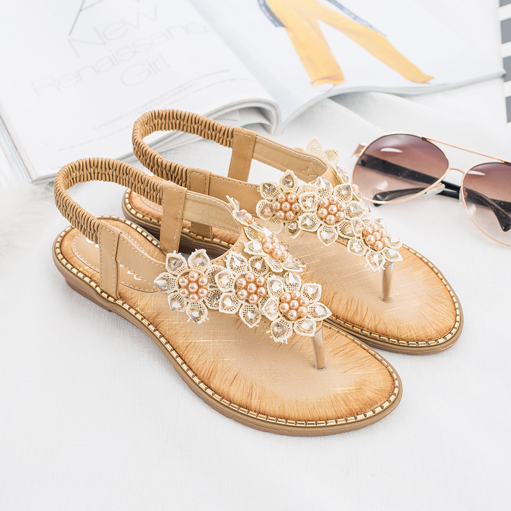 Pair of beige floral beaded wedge sandals with a PU sole, featuring delicate beaded floral designs and a low wedge heel. Perfect for casual summer wear.