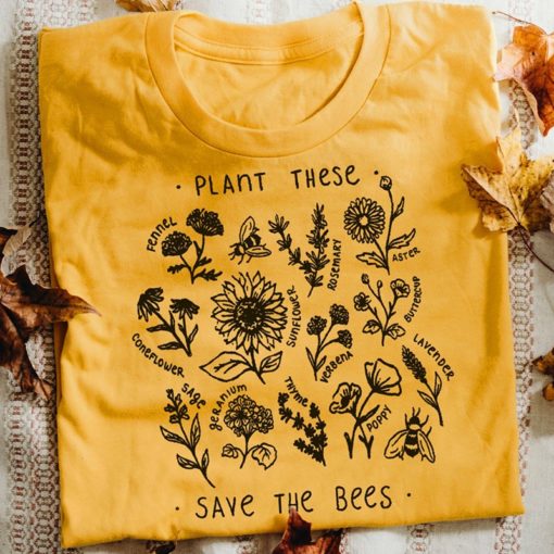 Yellow graphic t-shirt with "Plant These, Save the Bees" print, featuring illustrations of bee-friendly flowers like sunflowers and lavender.