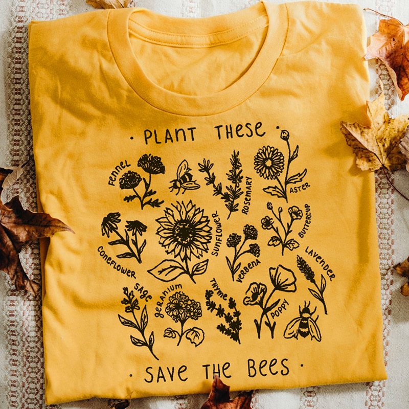 Yellow graphic t-shirt with "Plant These, Save the Bees" print, featuring illustrations of bee-friendly flowers like sunflowers and lavender.