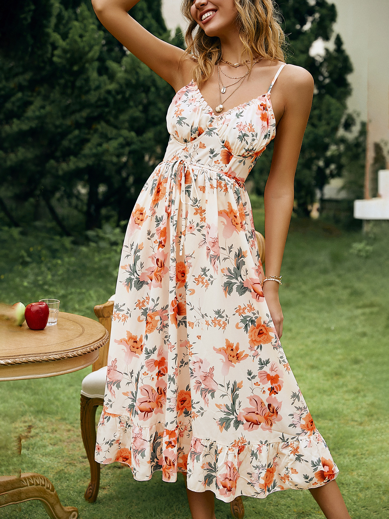 Elegant suspender midi dress with a high-waisted A-line skirt, open back, and tie belt, designed for a sophisticated and feminine look.