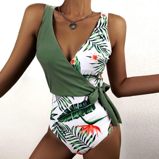 Tropical Patchwork One Piece Swimsuit with wrap-tie detail and floral print.