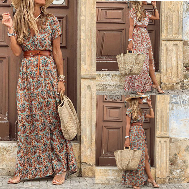 Woman wearing a bohemian print midi dress with a high waist and V-neck, paired with a straw hat and a woven bag for a chic summer look.