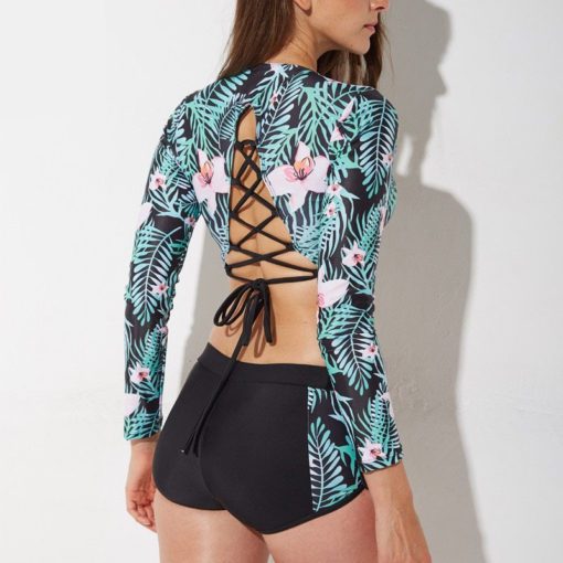 Riquinya Women's Rash Guard made from polyester and spandex with a printed design, perfect for swim and sports.
