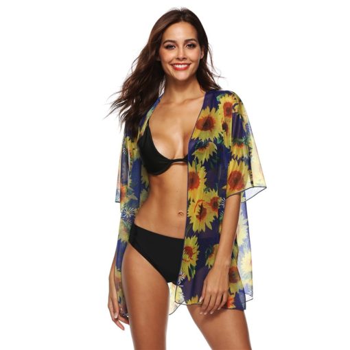 Woman wearing a sunflower print sheer cover-up, perfect for beach and poolside lounging, featuring a notched collar and half sleeves for a lightweight, breezy fit.
