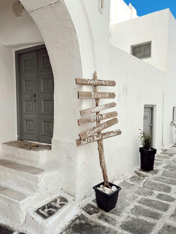 A sign by a wall in paros greece